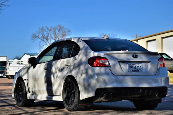Keith Fields’ white 2015 STI with black wheels and Mickey Thompson tires in AWD’s 2018 photo